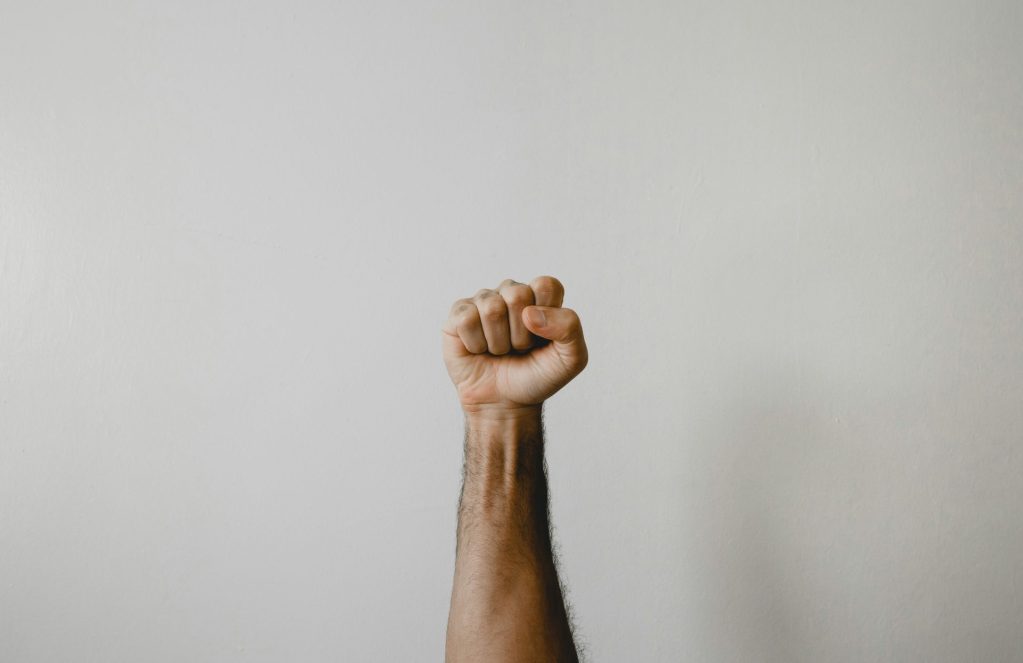 Man with fist clenched in protest